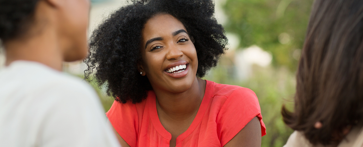 A woman smiling outdoors